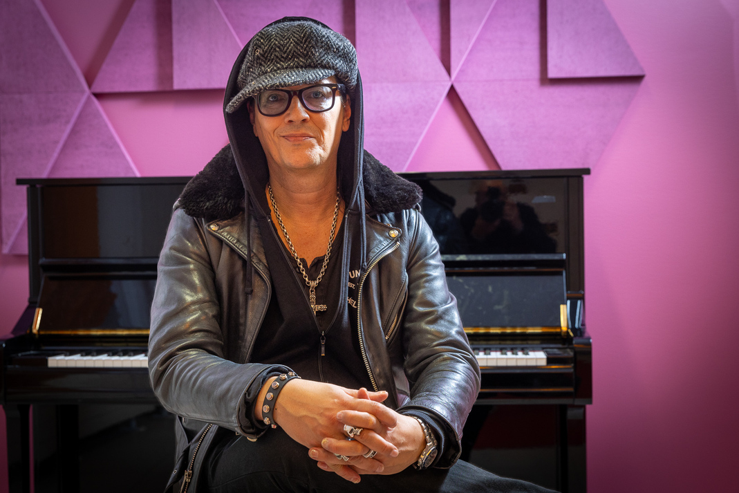 Jyrki 69 istuu violetiksi valaistun kirkkosalin pianon edessä.
